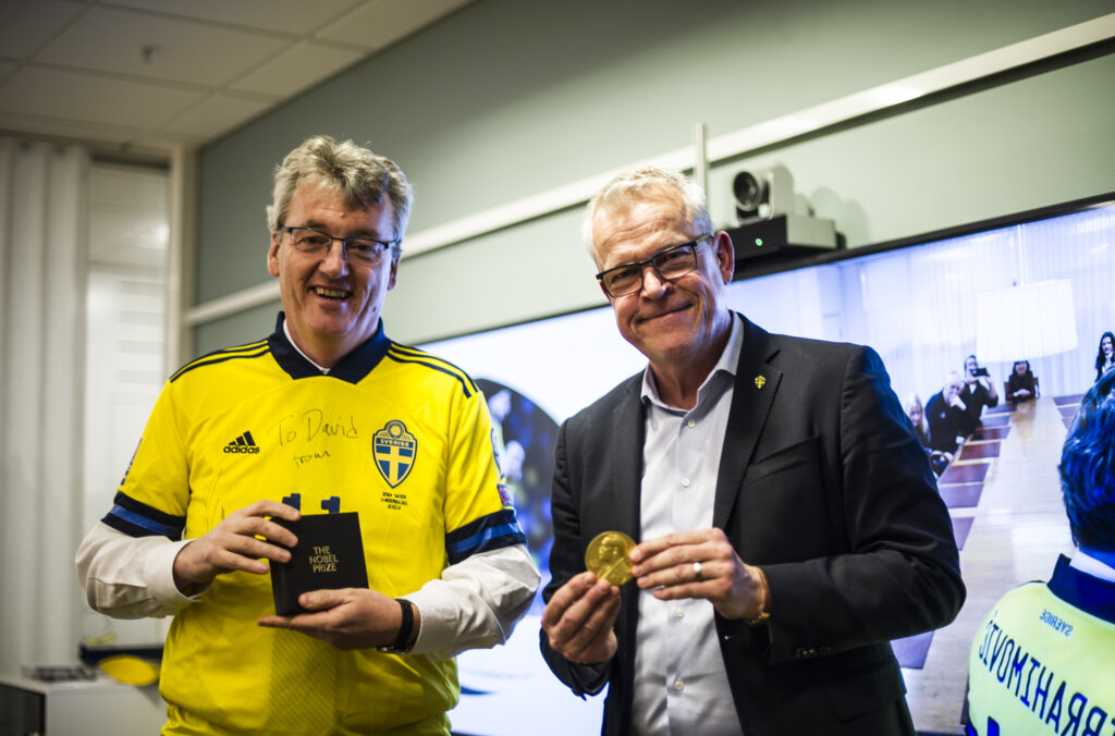 David MacMillan standing with Sweden national football team manager Janne Andersson.