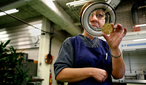 The medal is carefully examined