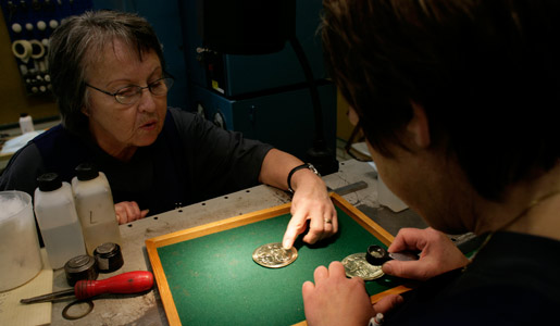 The medal is checked with a magnifying glass
